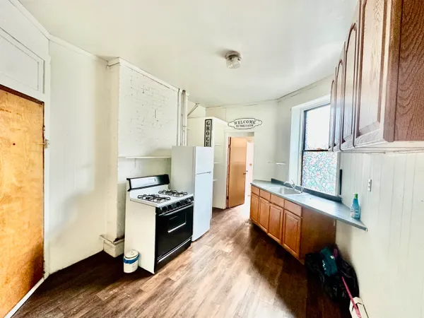 a kitchen with stainless steel appliances granite countertop a stove and a refrigerator