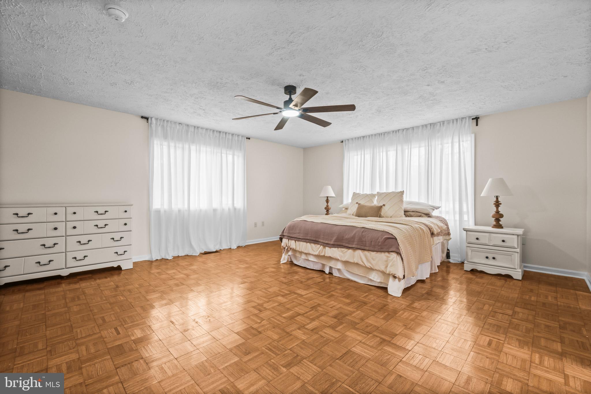 10514 Willetts Crossing Road White Plains, MD 20695 - Photo 12 of 41 a bedroom with a bed and a chandelier