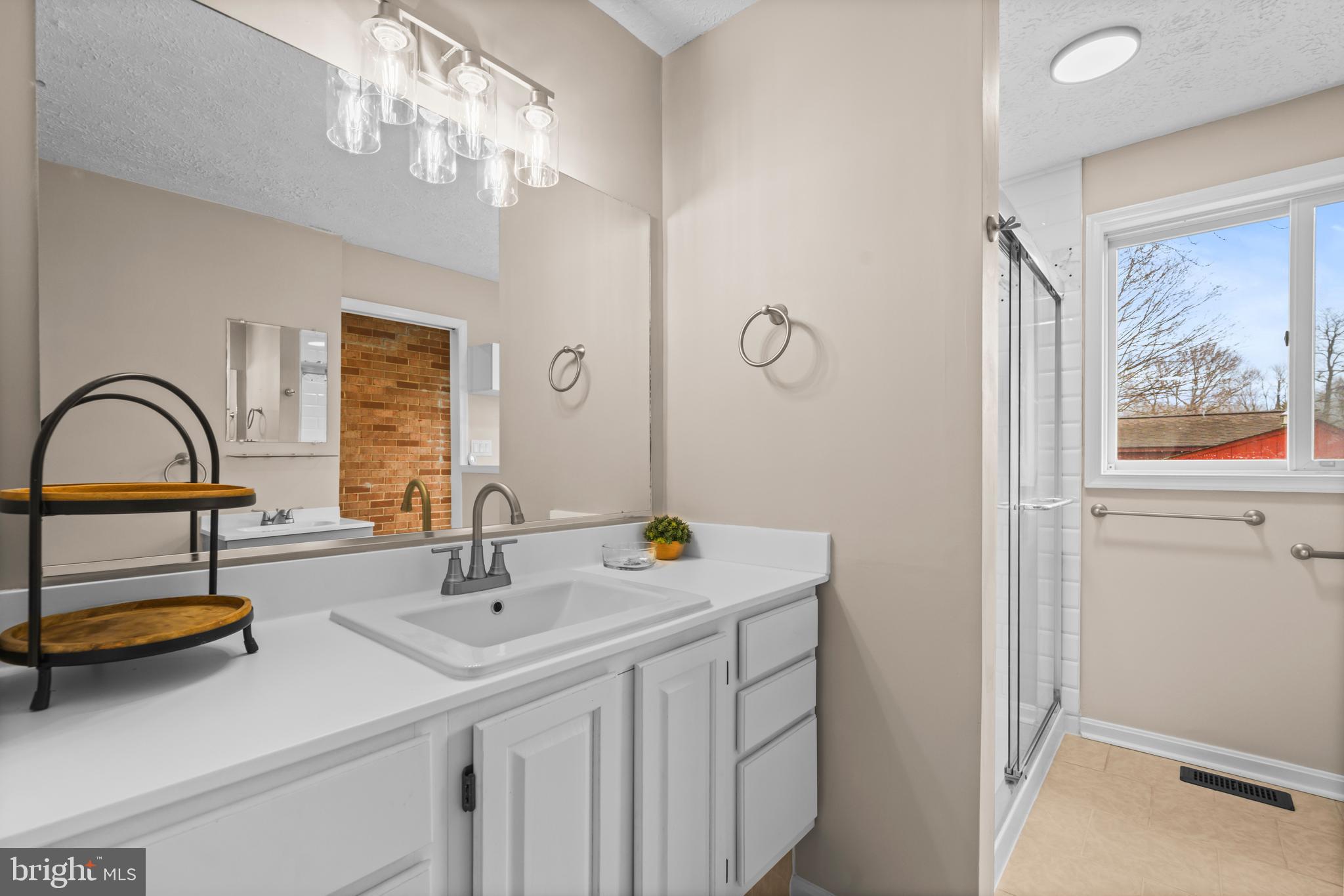 10514 Willetts Crossing Road White Plains, MD 20695 - Photo 17 of 41 a bathroom with a sink and a mirror