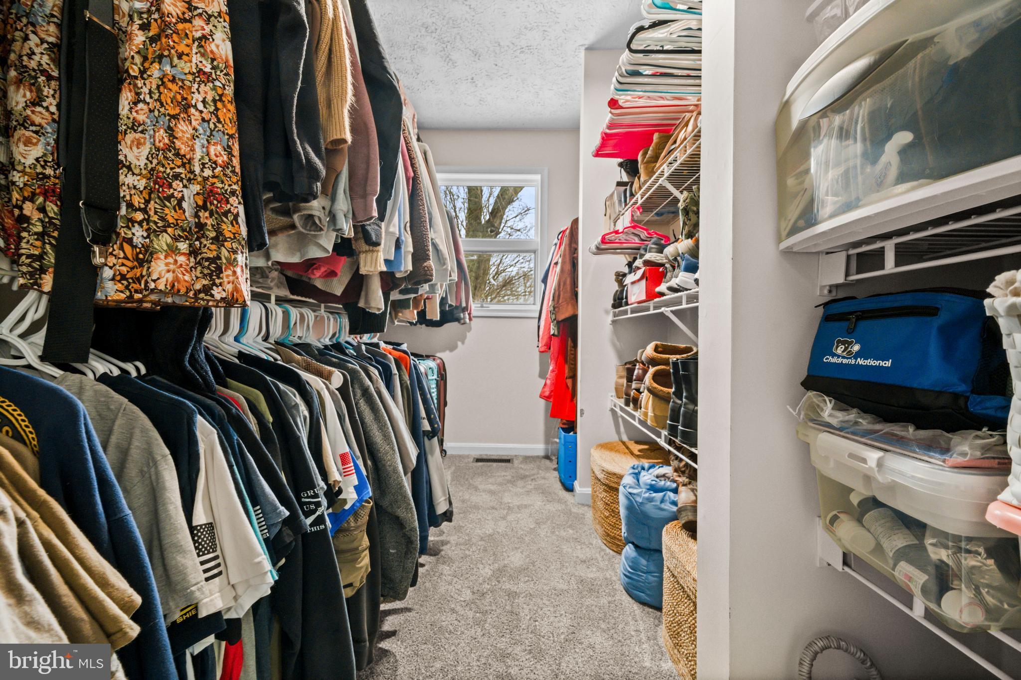 10514 Willetts Crossing Road White Plains, MD 20695 - Photo 20 of 41 a view of walk in closet with clothes and shoes