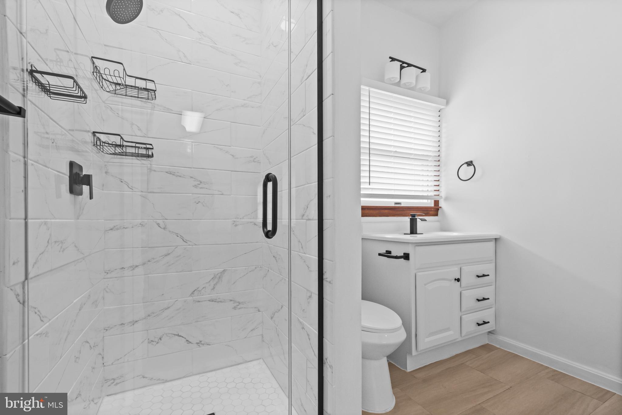 10514 Willetts Crossing Road White Plains, MD 20695 - Photo 30 of 41 a bathroom with a granite countertop toilet a sink a mirror and shower