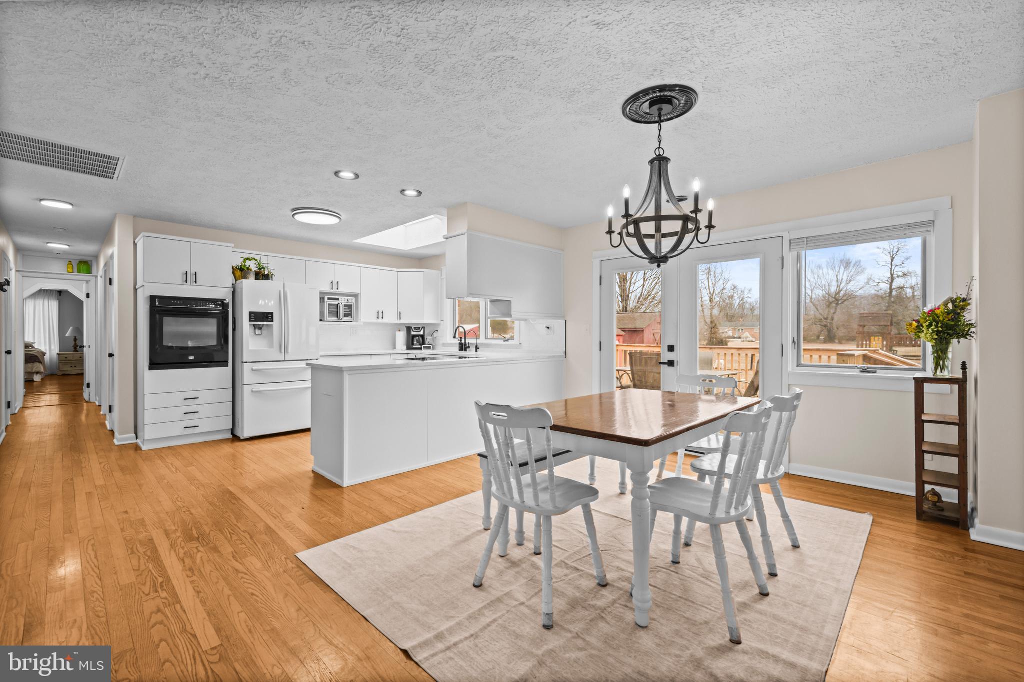 10514 Willetts Crossing Road White Plains, MD 20695 - Photo 7 of 41 a view of a dining room with furniture and wooden floor