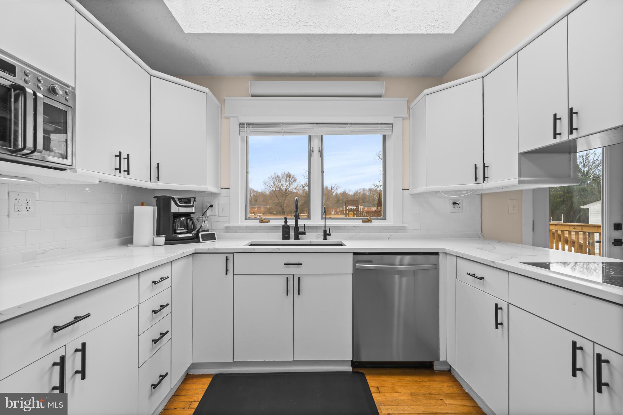 10514 Willetts Crossing Road White Plains, MD 20695 - Photo 10 of 41 a kitchen with cabinets appliances a sink and a window