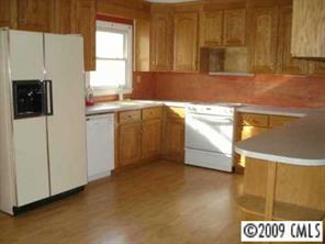 320 Macedonia Church Road Monroe, NC 28112 - Photo 3 of 4 a kitchen with stainless steel appliances white cabinets and a window
