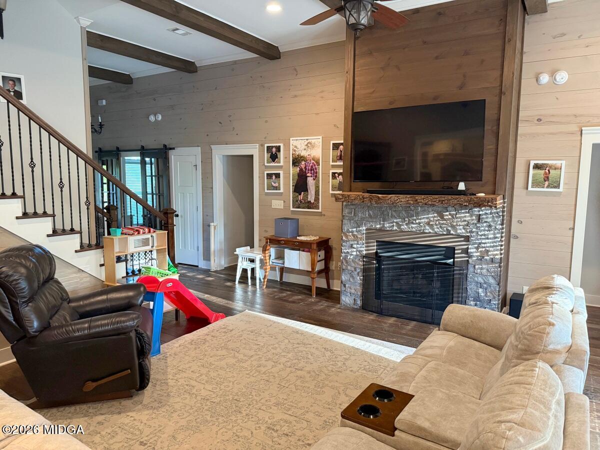 917 Broken Arrow Trail Perry, GA 31069 - Photo 16 of 34 a living room with furniture a flat screen tv and a fireplace