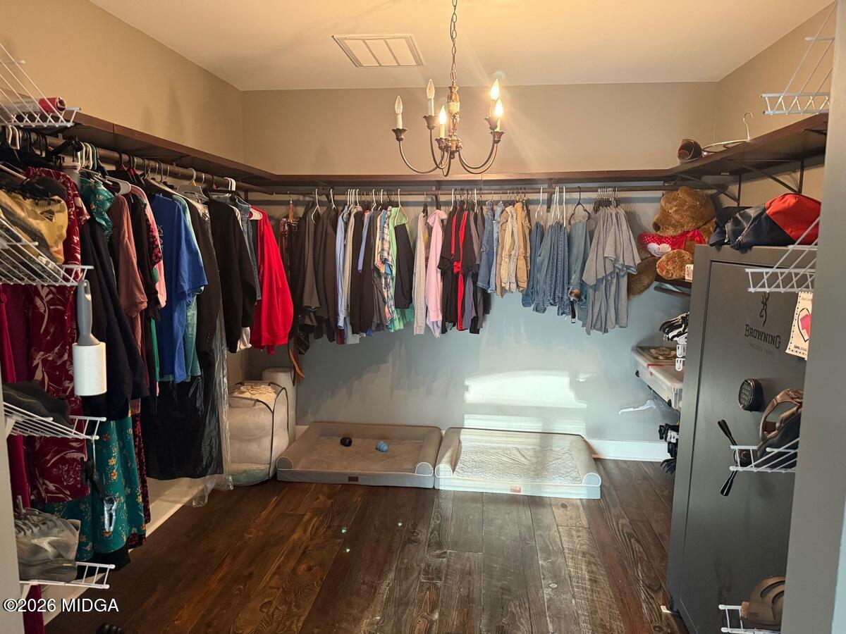 917 Broken Arrow Trail Perry, GA 31069 - Photo 27 of 34 a view of walk in closet with clothes and shoes