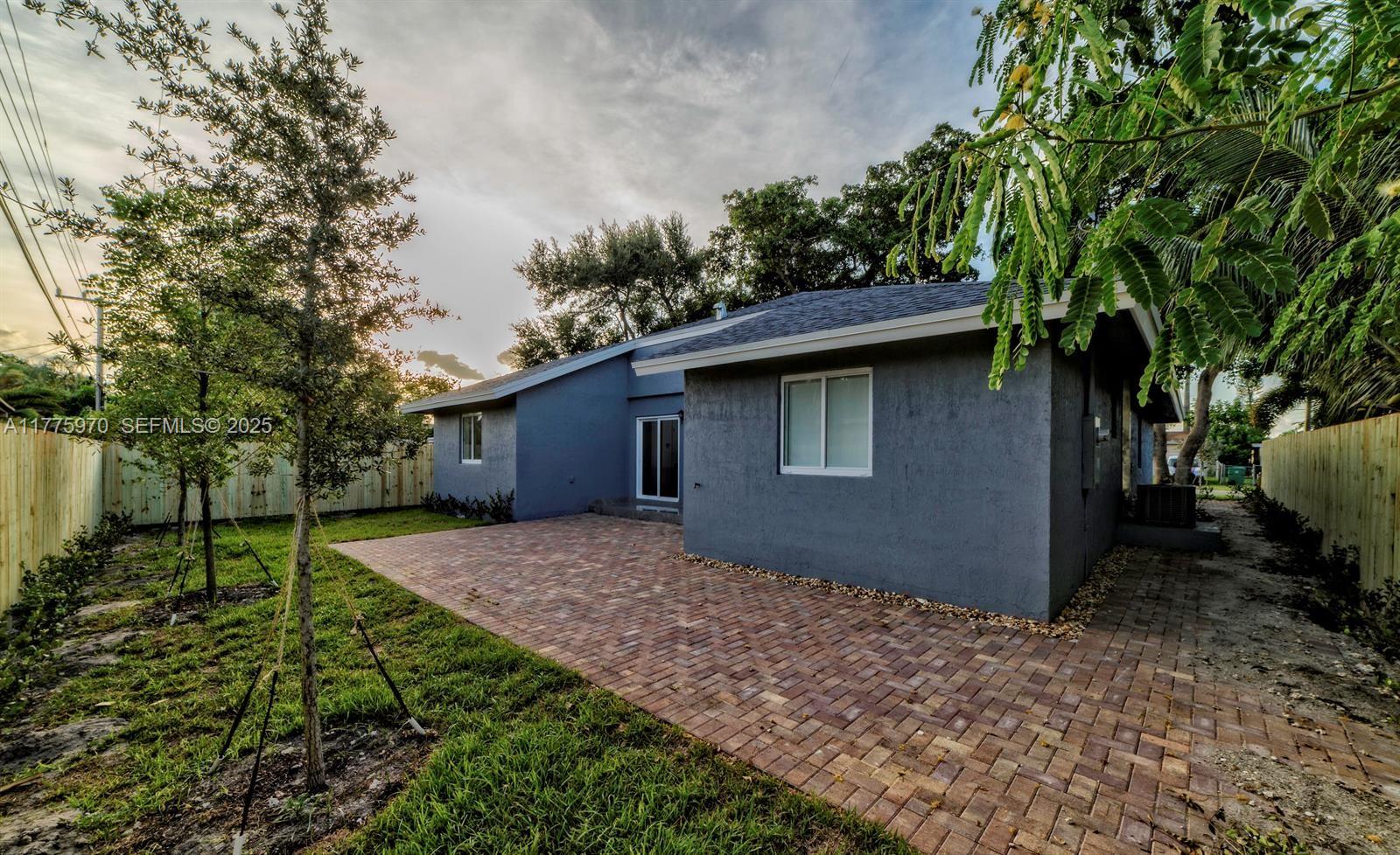 4070 Southwest 49th Court Dania Beach, FL 33314 - Photo 15 of 16 a backyard of a house with lots of green space