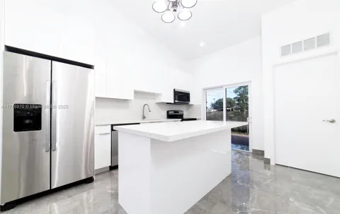 a kitchen with stainless steel appliances a refrigerator sink and stove