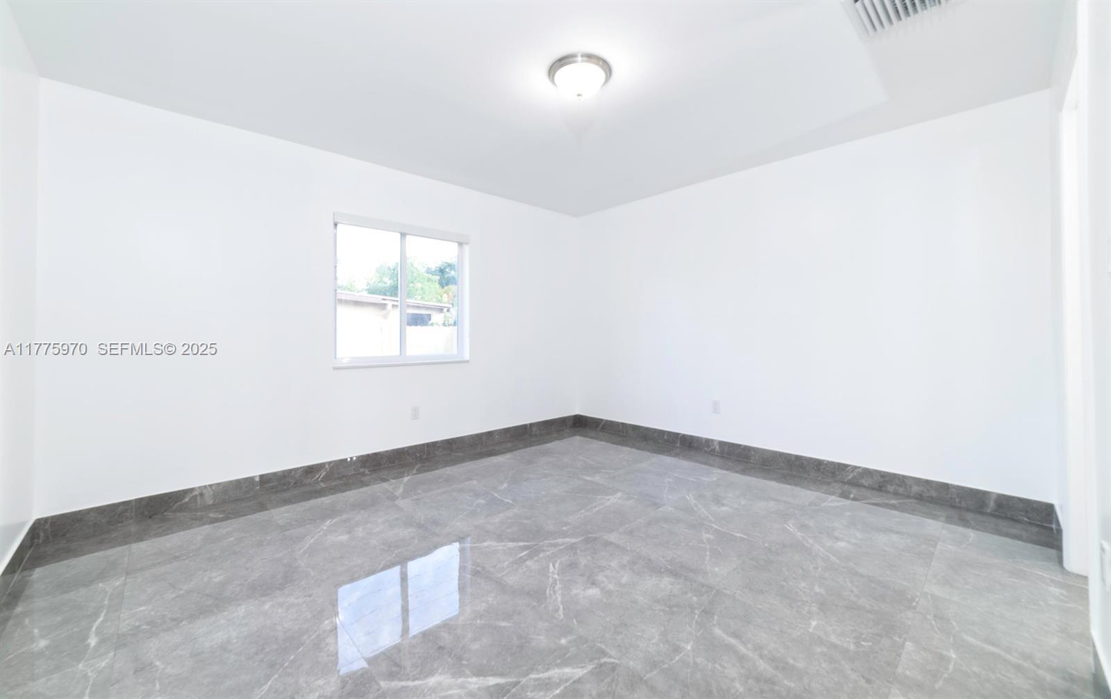 4070 Southwest 49th Court Dania Beach, FL 33314 - Photo 7 of 16 an empty room with windows