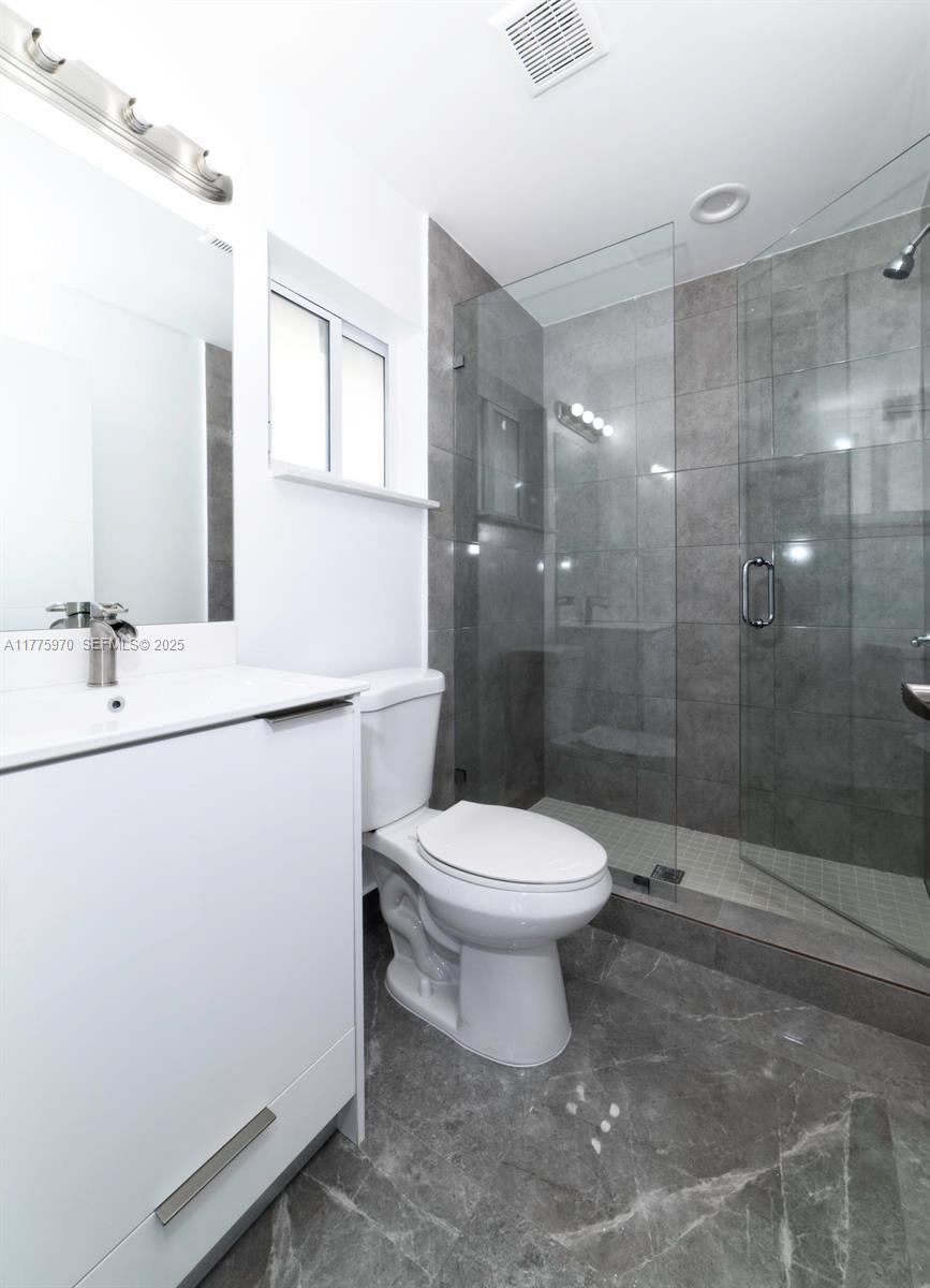 4070 Southwest 49th Court Dania Beach, FL 33314 - Photo 8 of 16 a bathroom with a toilet sink and shower