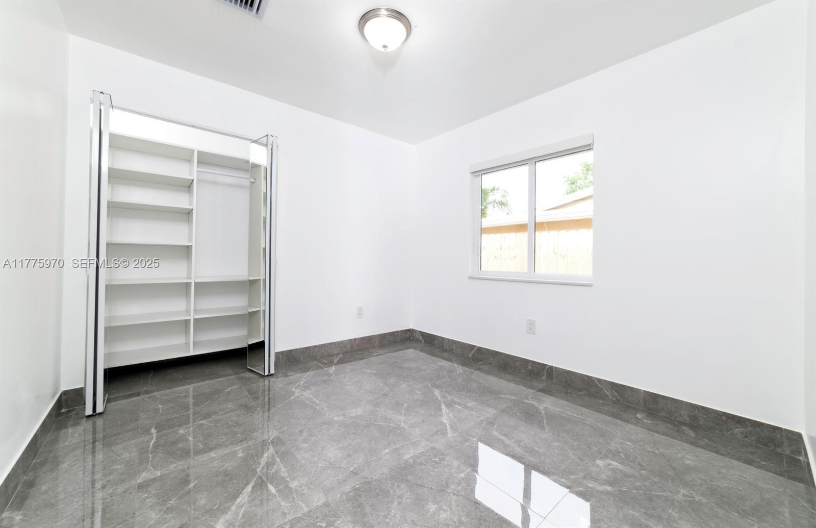 4070 Southwest 49th Court Dania Beach, FL 33314 - Photo 10 of 16 a view of an empty room with a window