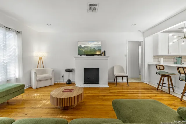 a living room with furniture and a fireplace