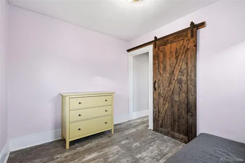 a living room with furniture and a large mirror
