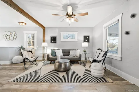 a living room with furniture and a view of kitchen