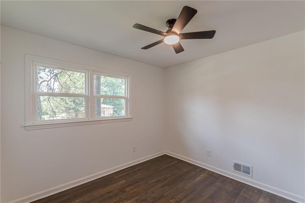 2352 Glendale Drive Decatur, GA 30032 - Photo 18 of 39 an empty room with wooden floor and windows