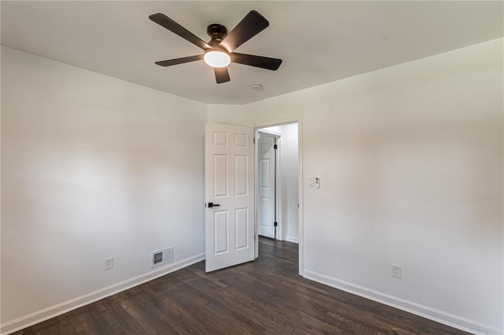 2352 Glendale Drive Decatur, GA 30032 - Photo 19 of 39 an empty room with wooden floor and a ceiling fan