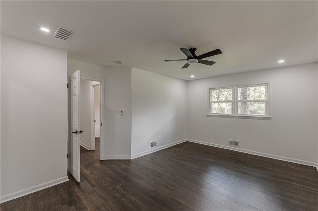 2352 Glendale Drive Decatur, GA 30032 - Photo 23 of 39 an empty room with wooden floor and a ceiling fan