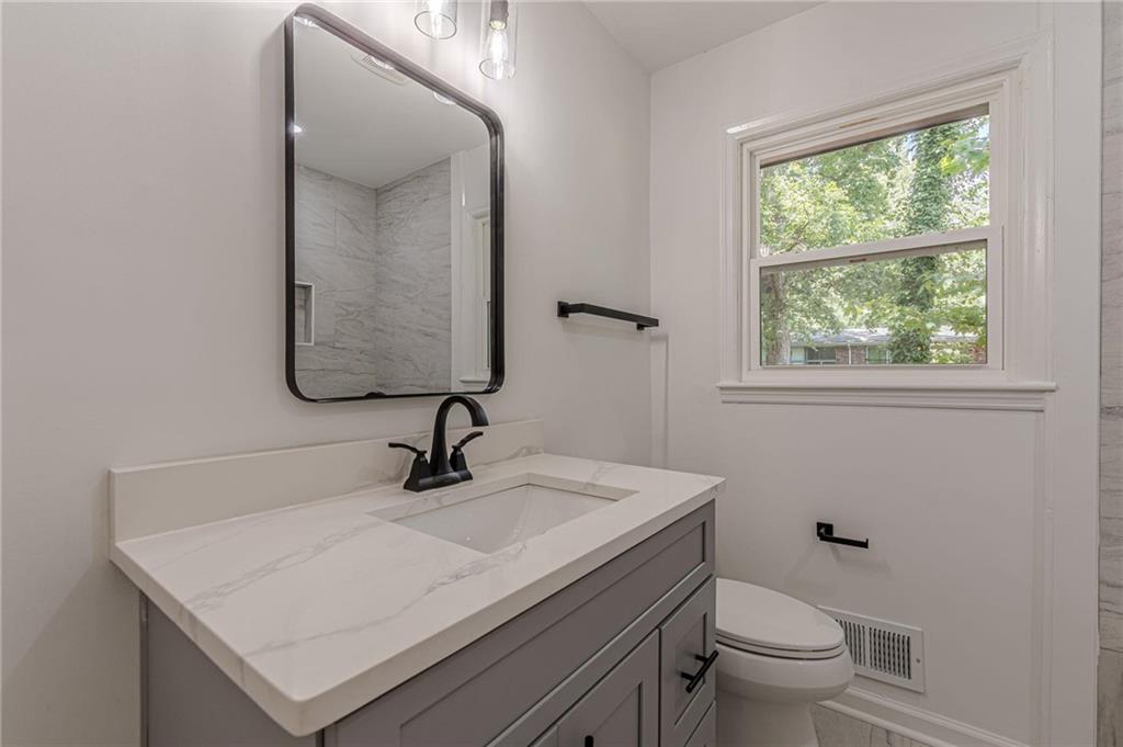 2352 Glendale Drive Decatur, GA 30032 - Photo 26 of 39 a bathroom with a sink toilet and window