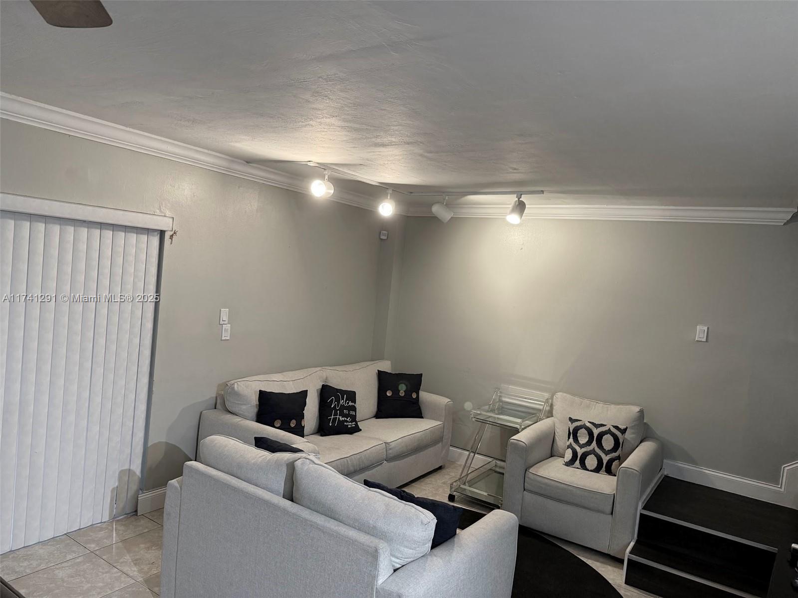 9050 Northwest 28th Street, Unit 110 Coral Springs, FL 33065 - Photo 13 of 13 a living room with furniture and a couch