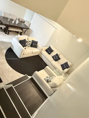 a view of living room with furniture and air hockey table