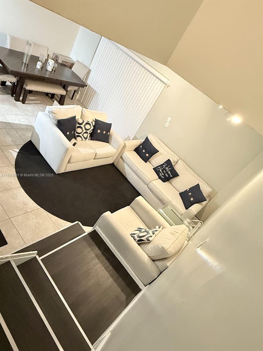 9050 Northwest 28th Street, Unit 110 Coral Springs, FL 33065 - Photo 2 of 13 a view of living room with furniture and air hockey table