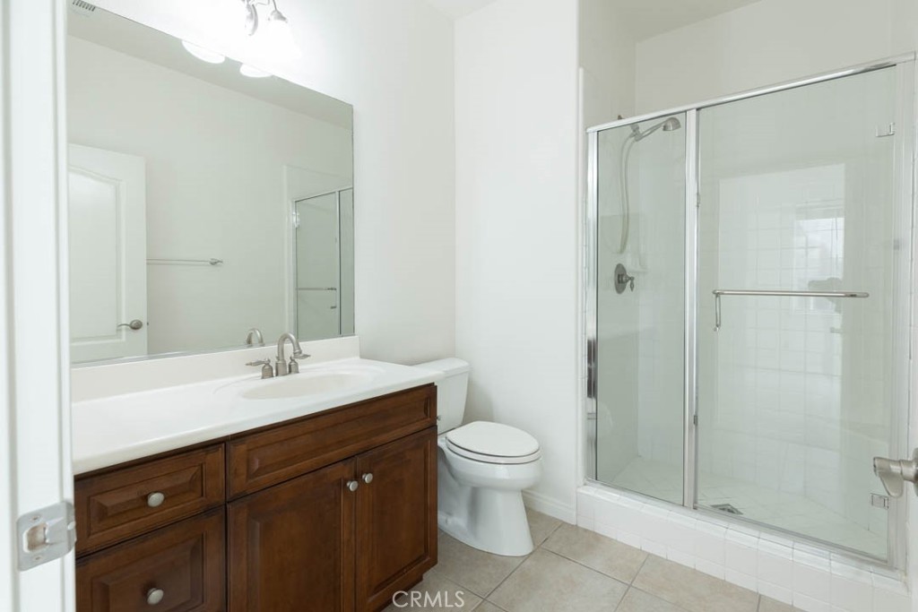 40 Tea Garden Irvine, CA 92620 - Photo 11 of 27 a bathroom with a double vanity sink toilet and shower