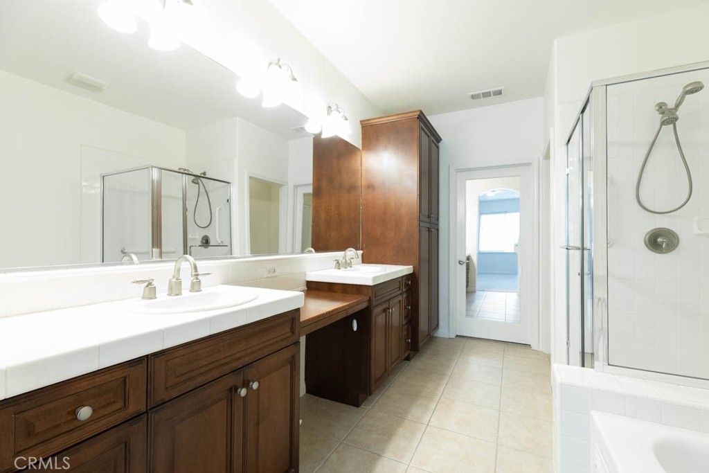 40 Tea Garden Irvine, CA 92620 - Photo 15 of 27 a spacious bathroom with a double vanity sink mirror and shower