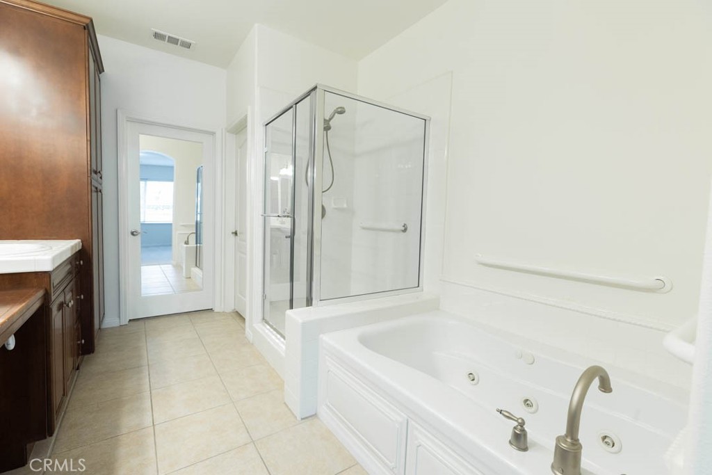 40 Tea Garden Irvine, CA 92620 - Photo 16 of 27 a bathroom with a bathtub and a shower