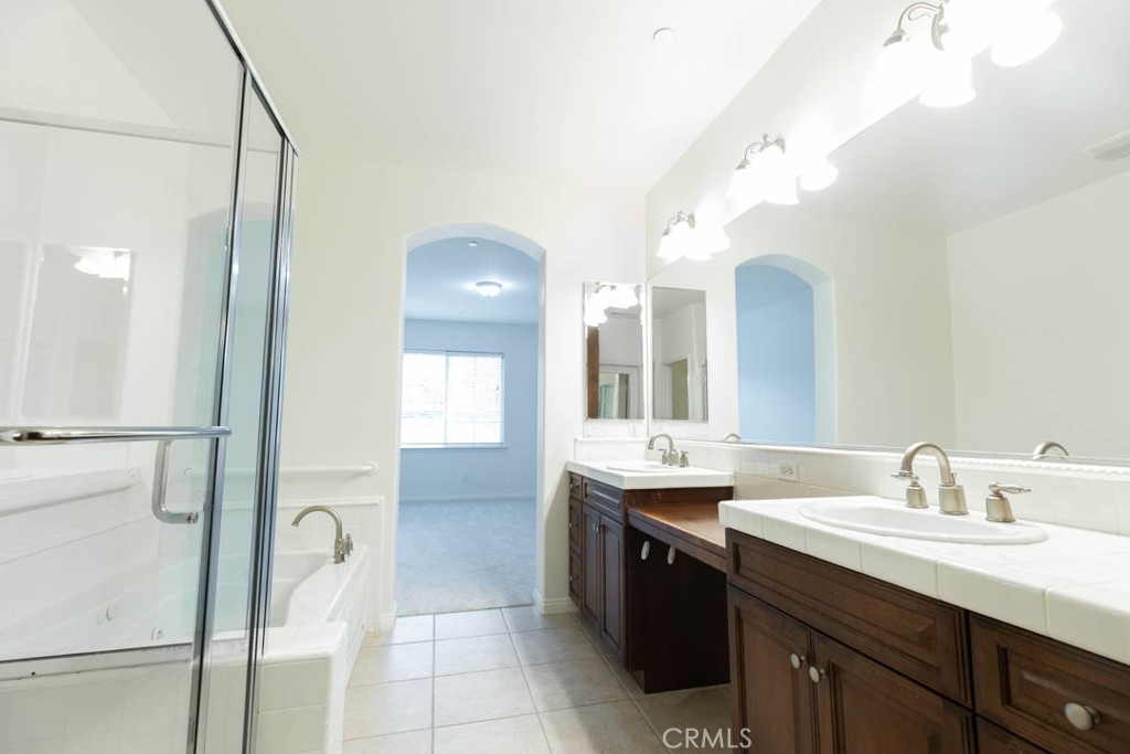 40 Tea Garden Irvine, CA 92620 - Photo 19 of 27 a bathroom with a double vanity sink and a mirror