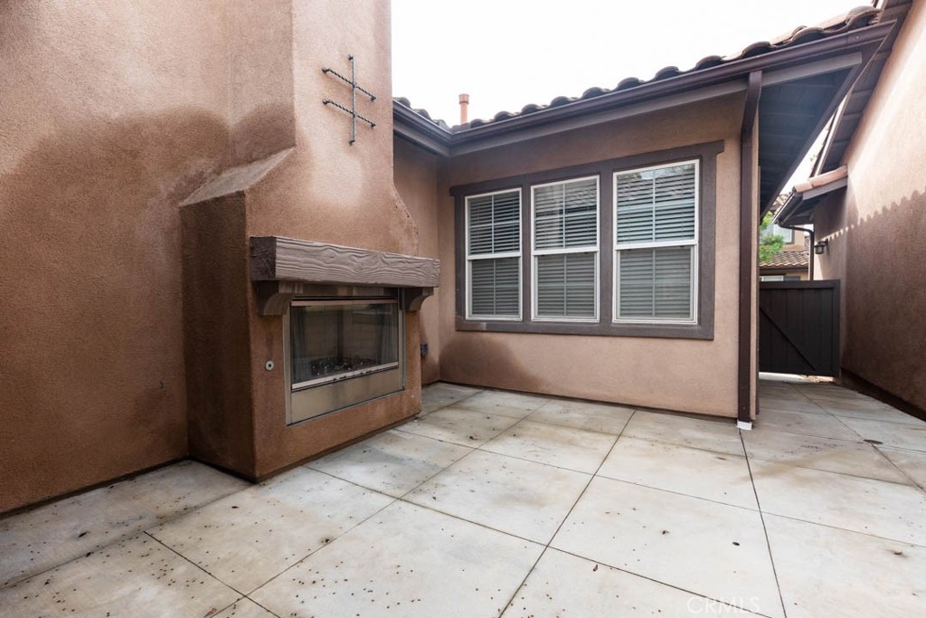 40 Tea Garden Irvine, CA 92620 - Photo 20 of 27 a view of an empty room with a fireplace and cabinet