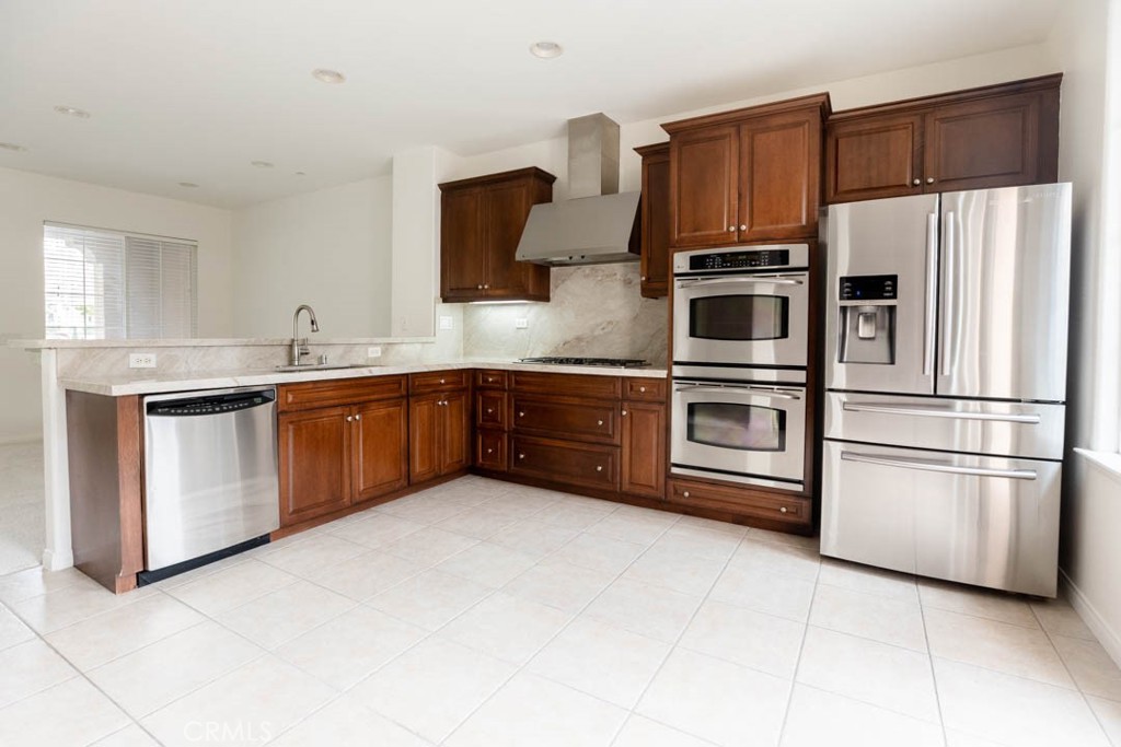 40 Tea Garden Irvine, CA 92620 - Photo 2 of 27 a kitchen with stainless steel appliances a sink cabinets and a refrigerator