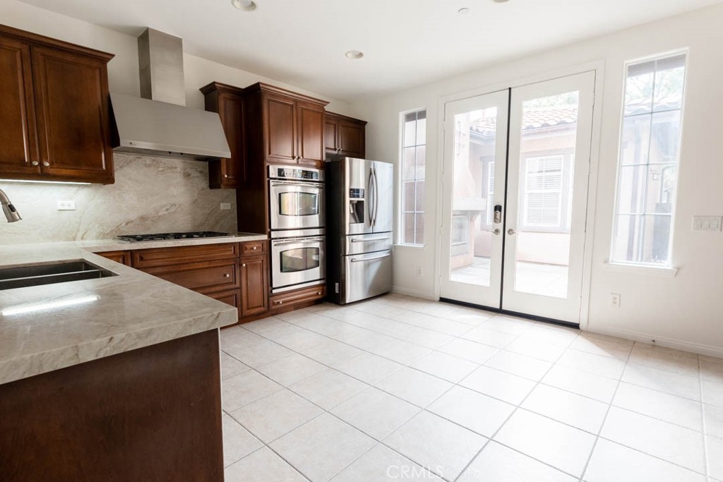 40 Tea Garden Irvine, CA 92620 - Photo 5 of 27 a kitchen with stainless steel appliances granite countertop a refrigerator and a sink