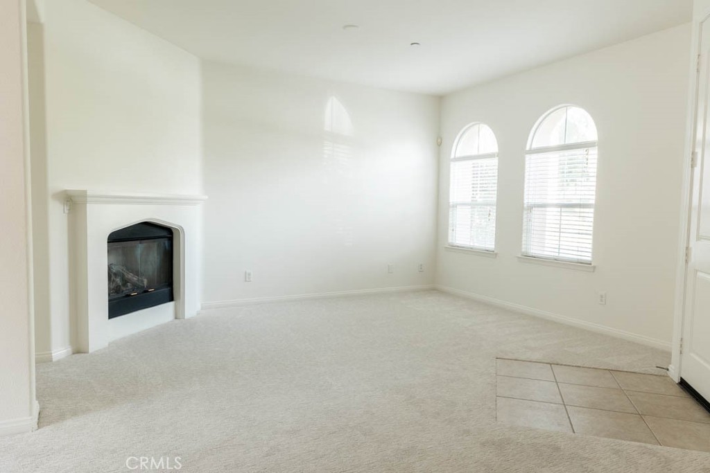 40 Tea Garden Irvine, CA 92620 - Photo 8 of 27 an empty room with windows and fireplace