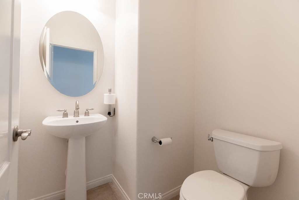 40 Tea Garden Irvine, CA 92620 - Photo 9 of 27 a bathroom with a toilet a sink and mirror