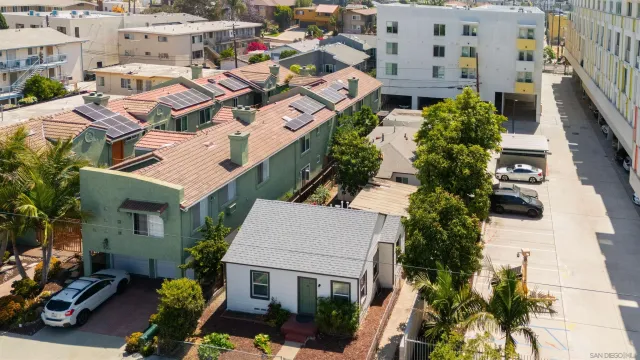 an aerial view of multiple houses with yard