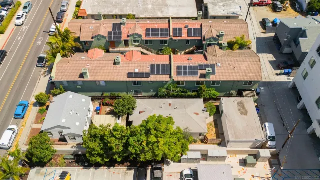 an aerial view of multiple houses with yard