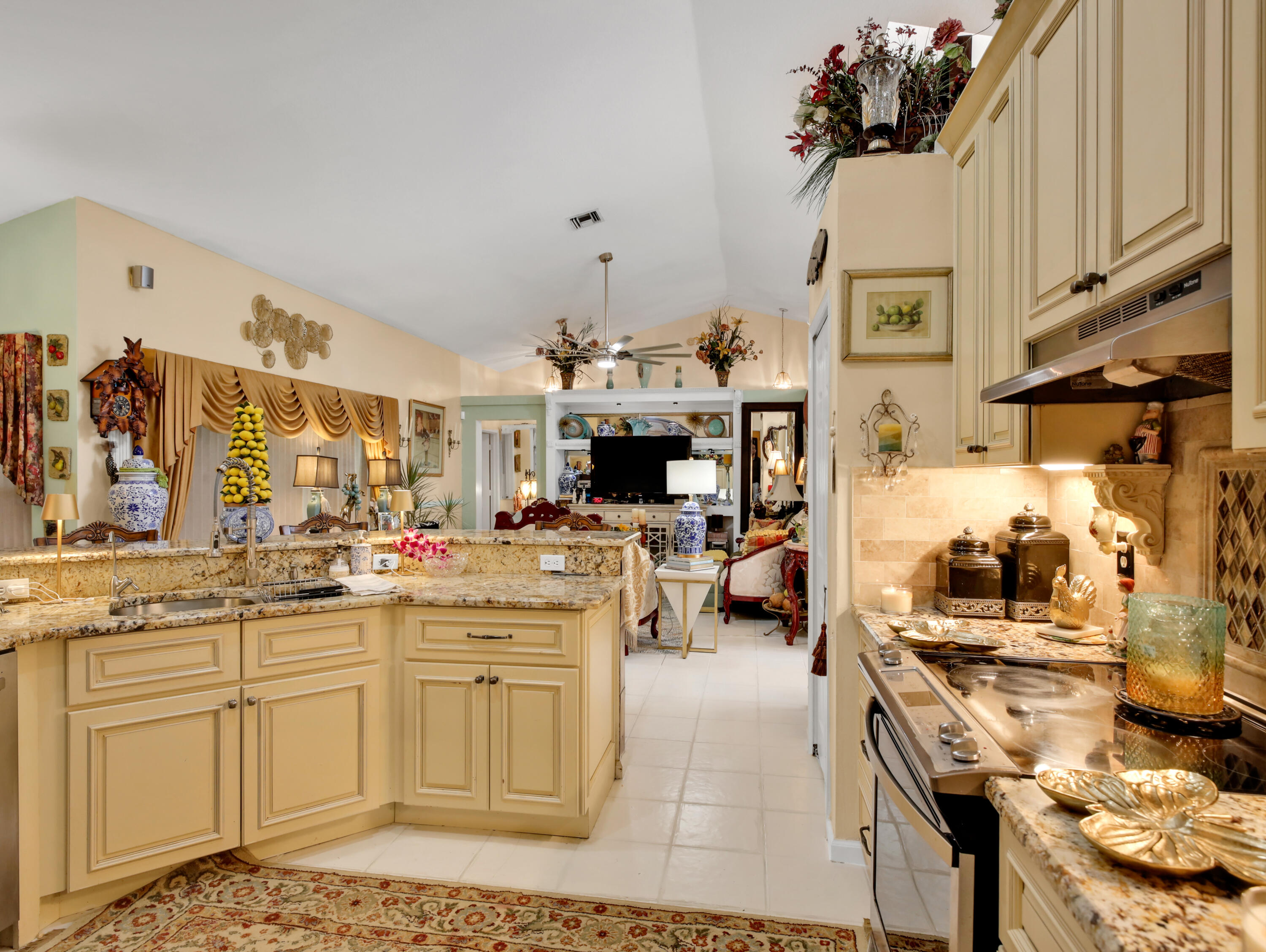 15049 85th Road North The Acreage, FL 33470 - Photo 32 of 60 a kitchen with a sink stove and cabinets