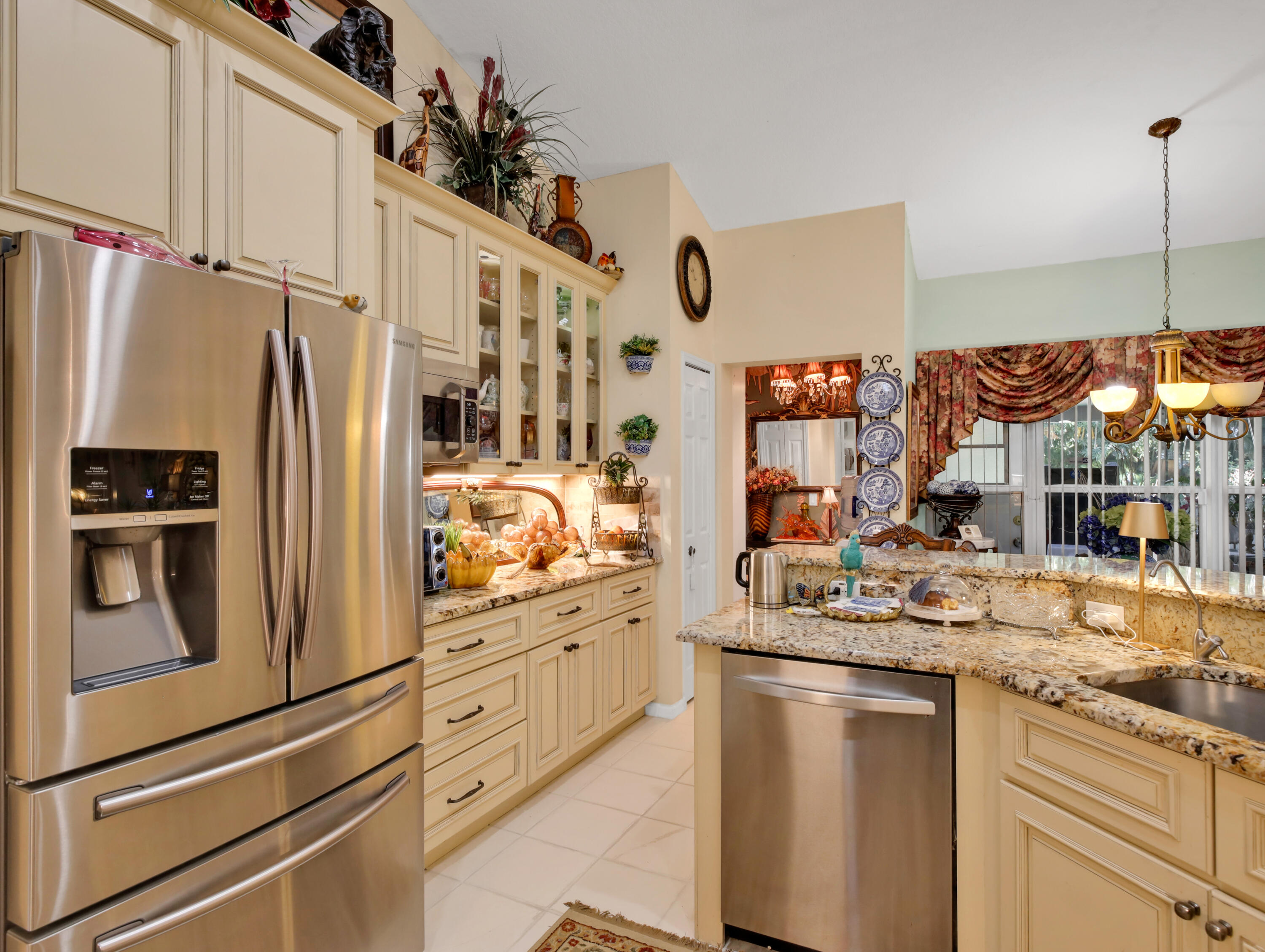 15049 85th Road North The Acreage, FL 33470 - Photo 33 of 60 a kitchen with stainless steel appliances granite countertop a refrigerator and a sink