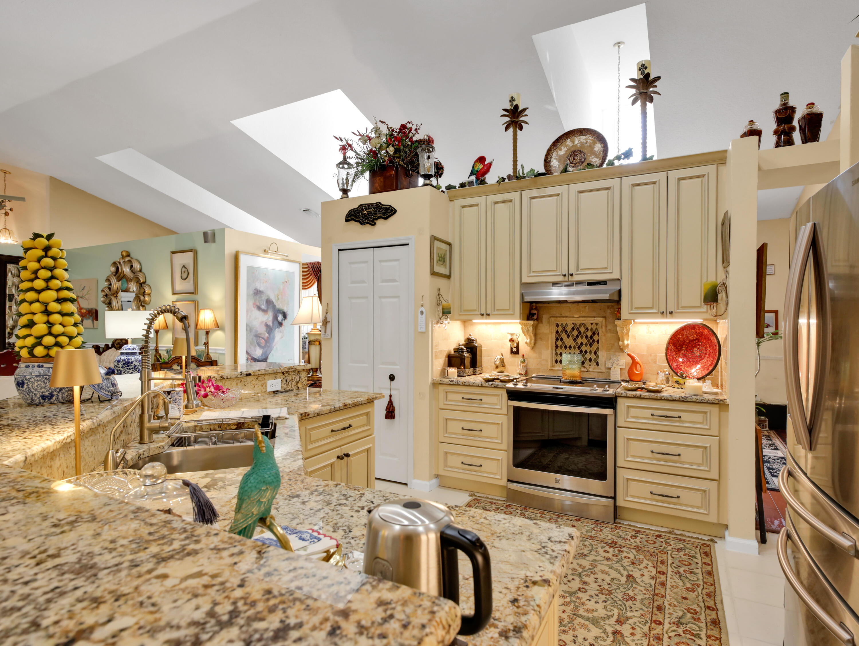 15049 85th Road North The Acreage, FL 33470 - Photo 35 of 60 a kitchen with stainless steel appliances kitchen island granite countertop a stove and cabinets