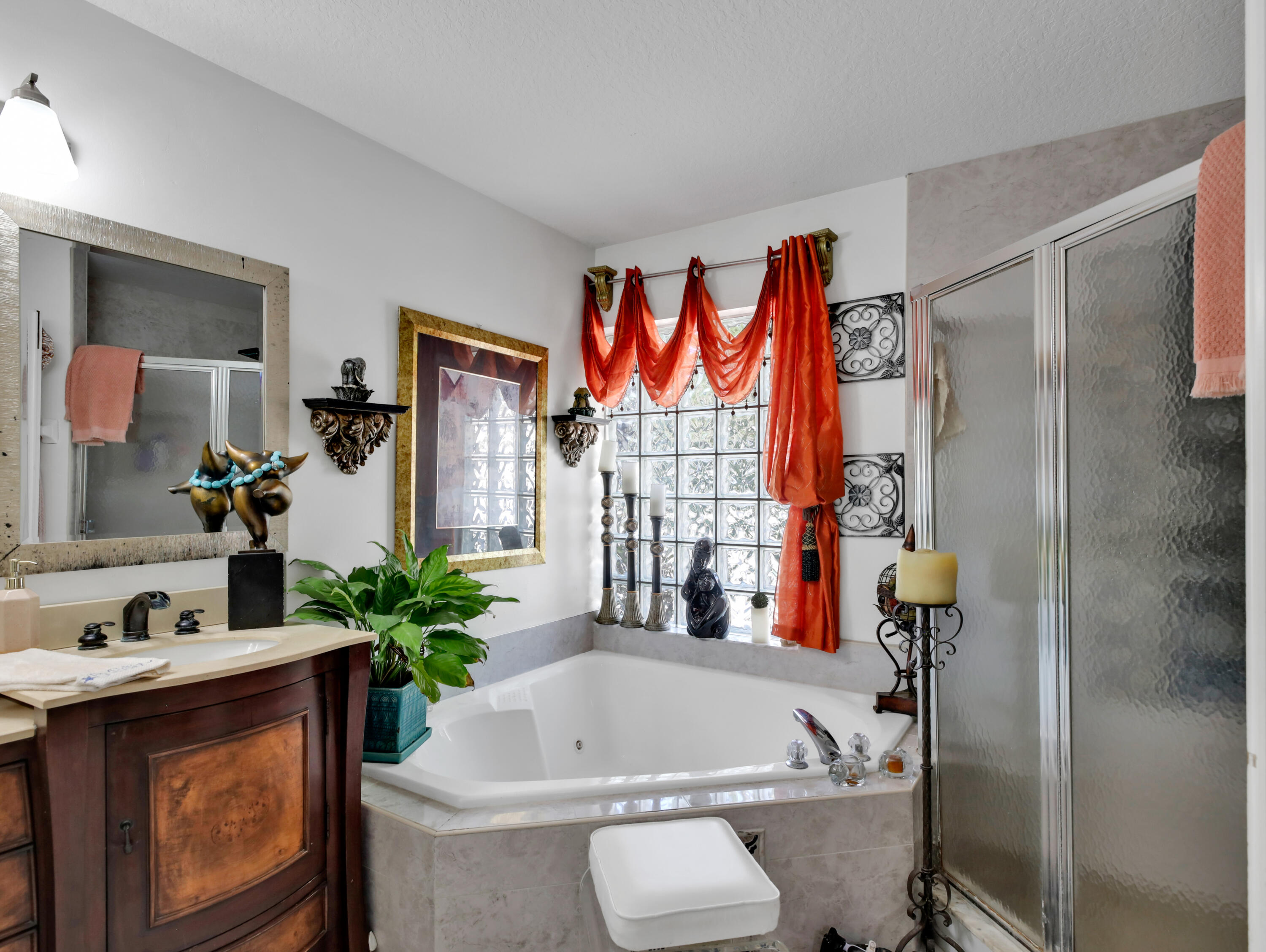 15049 85th Road North The Acreage, FL 33470 - Photo 45 of 60 a bath tub sitting next to a bathroom sink and a mirror