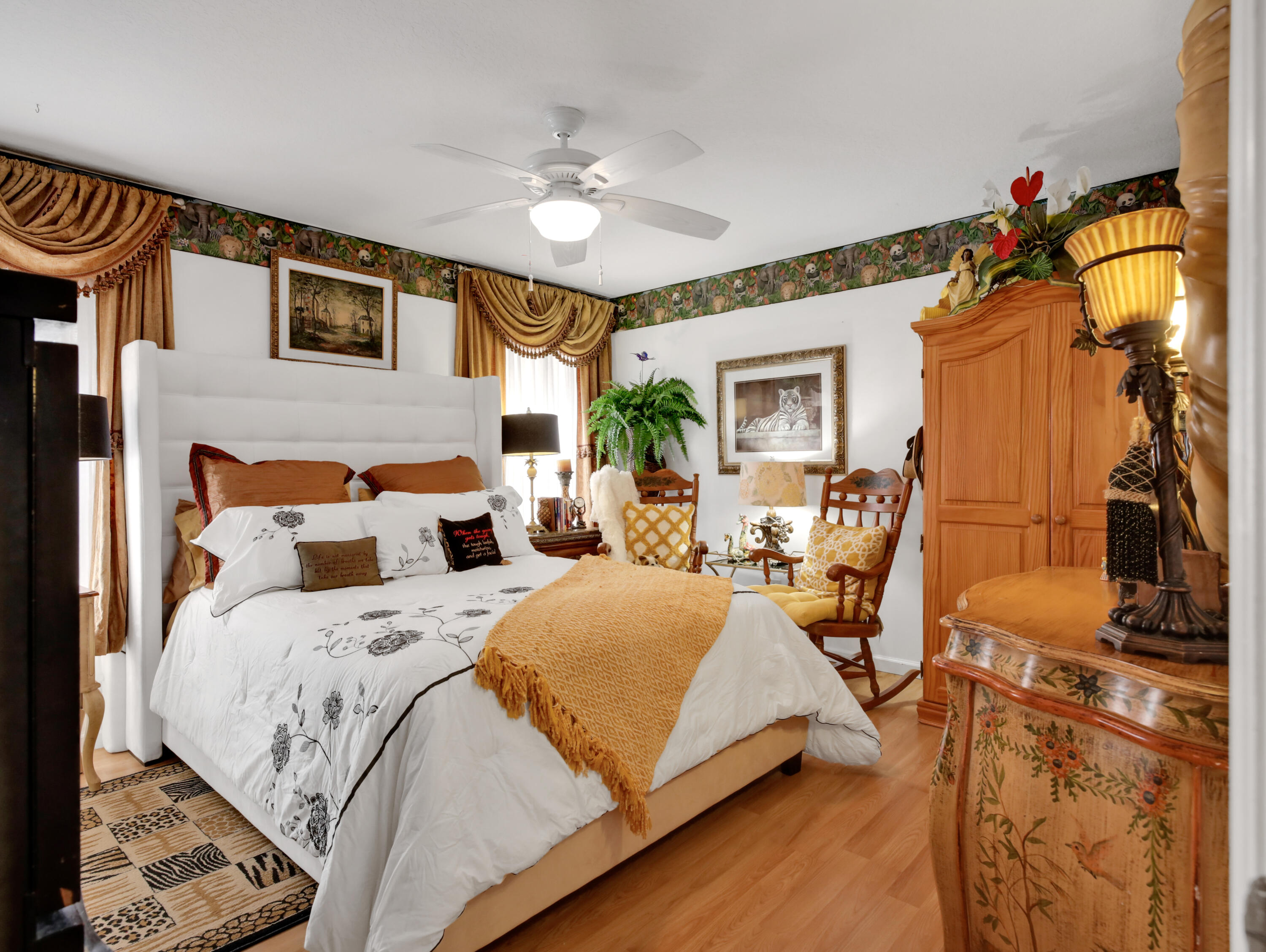 15049 85th Road North The Acreage, FL 33470 - Photo 55 of 60 a bedroom with bed and a chandelier