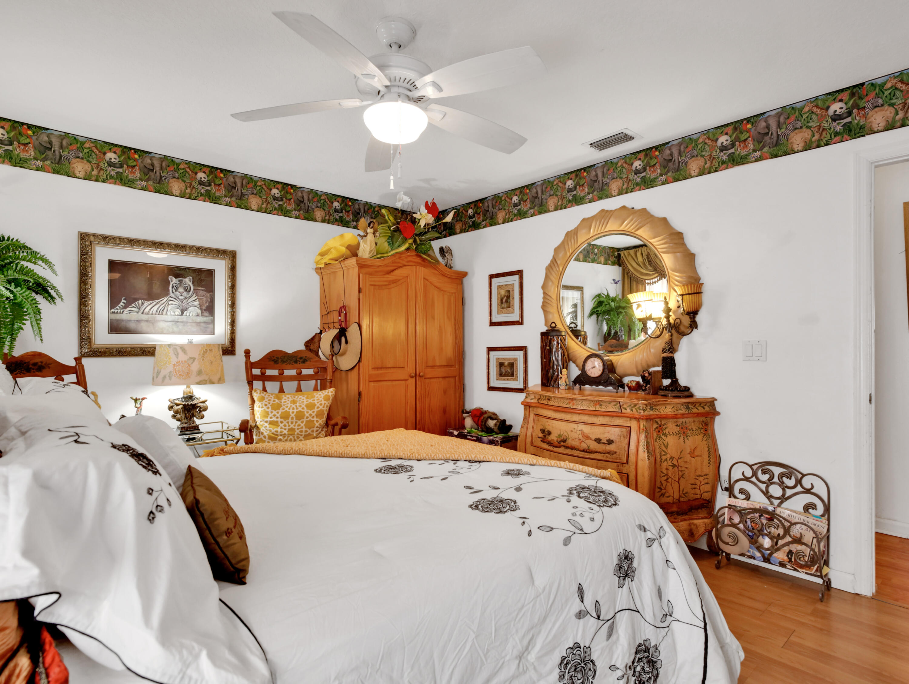 15049 85th Road North The Acreage, FL 33470 - Photo 57 of 60 a bedroom with a bed a dresser and potted plants