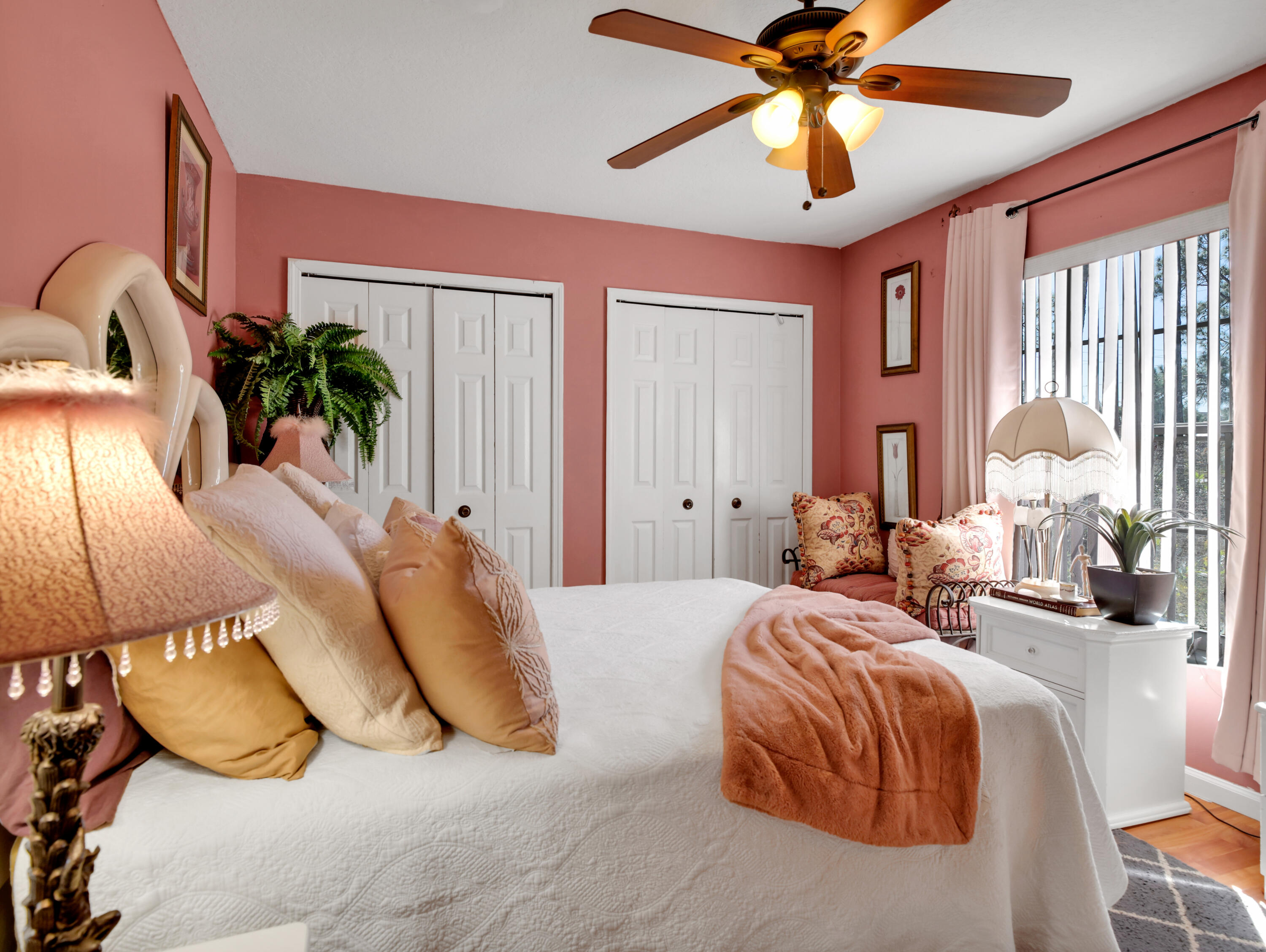 15049 85th Road North The Acreage, FL 33470 - Photo 59 of 60 a bedroom with a bed a chandelier and a large window
