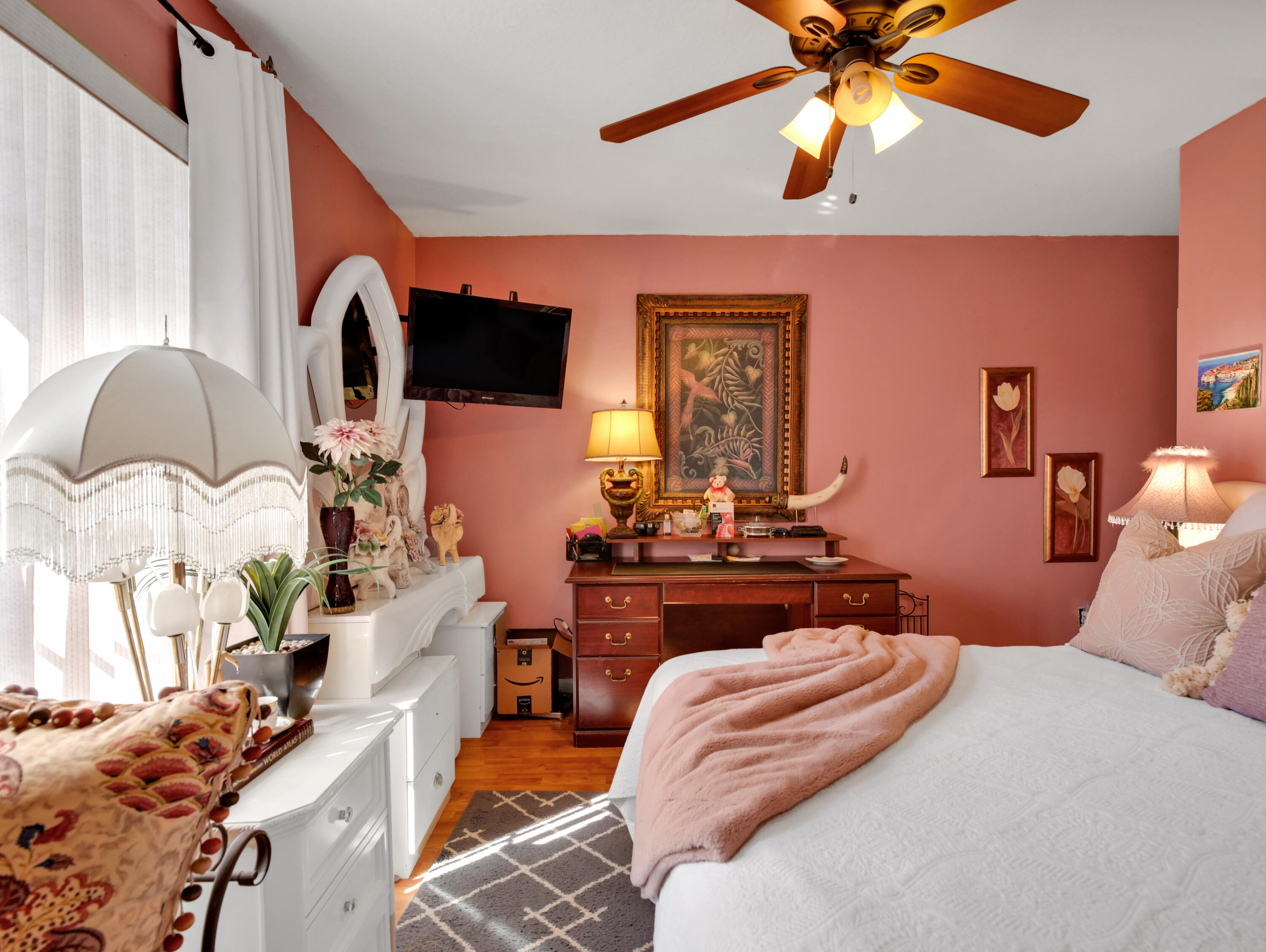 15049 85th Road North The Acreage, FL 33470 - Photo 60 of 60 a bedroom with a bed flat screen tv and a chandelier