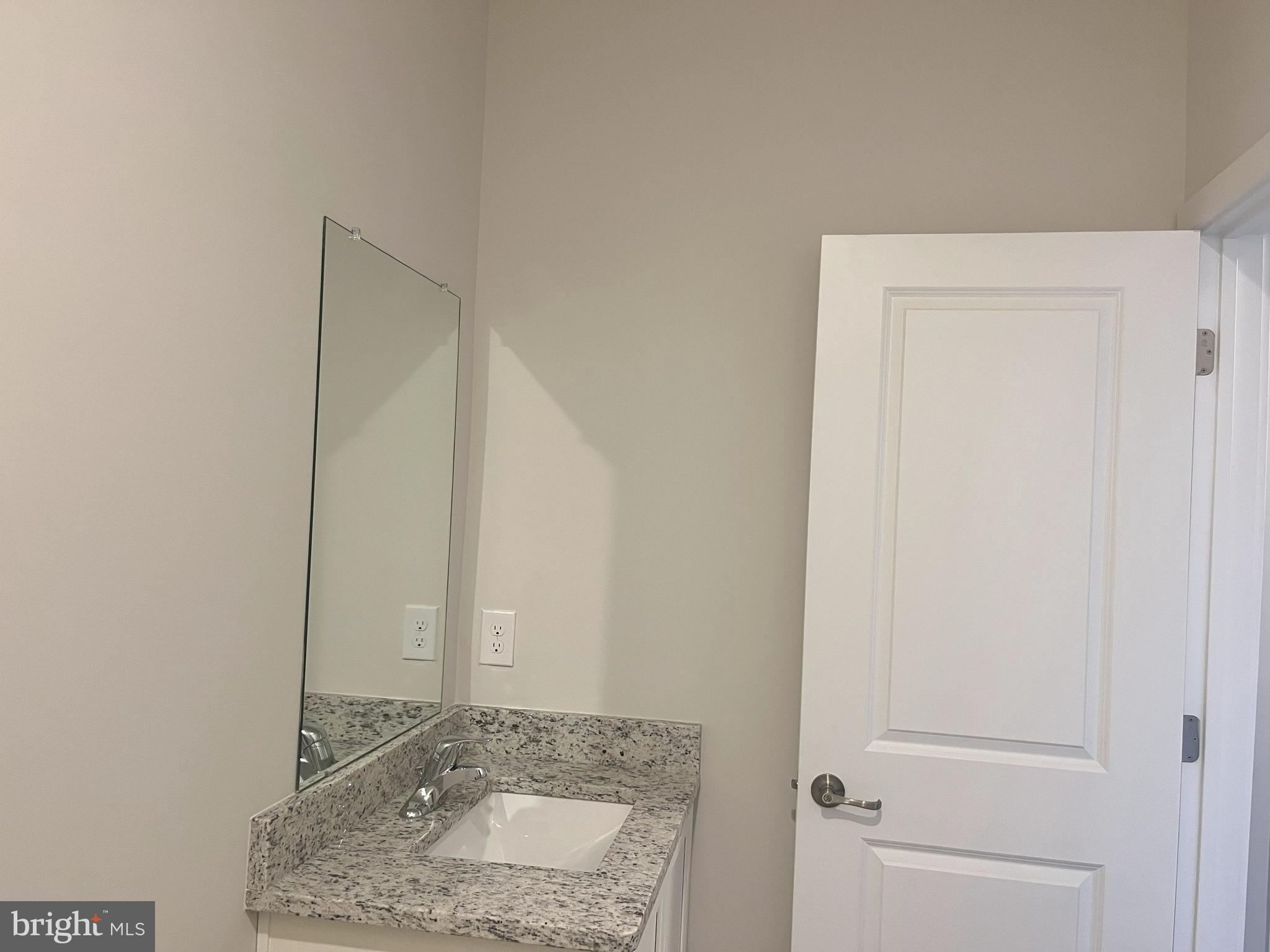 8 East Front Street Bridgeport, PA 19405 - Photo 21 of 38 a bathroom with a granite countertop sink and a mirror