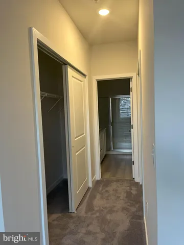 a view of a hallway with wooden shelves