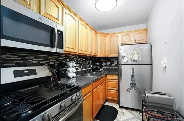 a kitchen with stainless steel appliances granite countertop a stove and a microwave