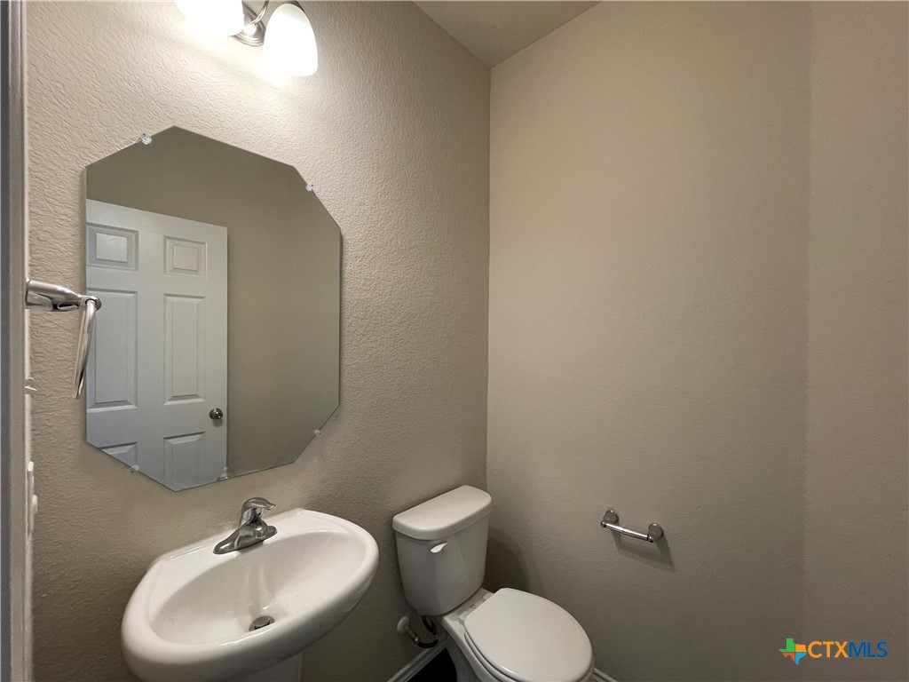 6416 Treiber Drive Temple, TX 76502 - Photo 15 of 19 a bathroom with a toilet sink and mirror