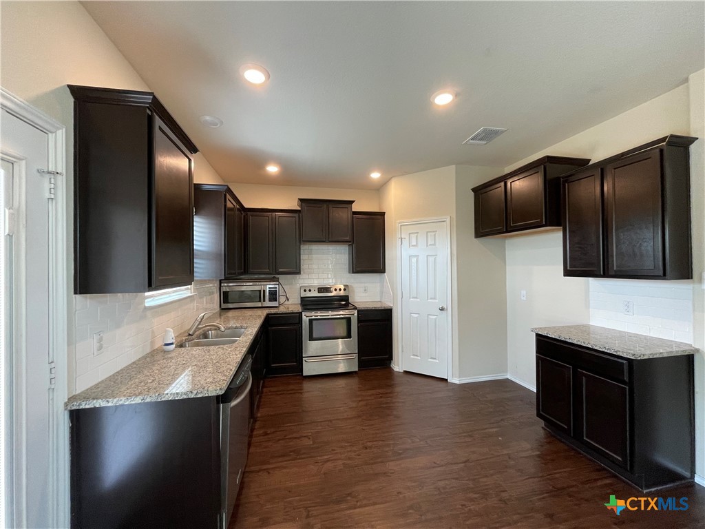 6416 Treiber Drive Temple, TX 76502 - Photo 5 of 19 a large kitchen with a large counter top stainless steel appliances and cabinets