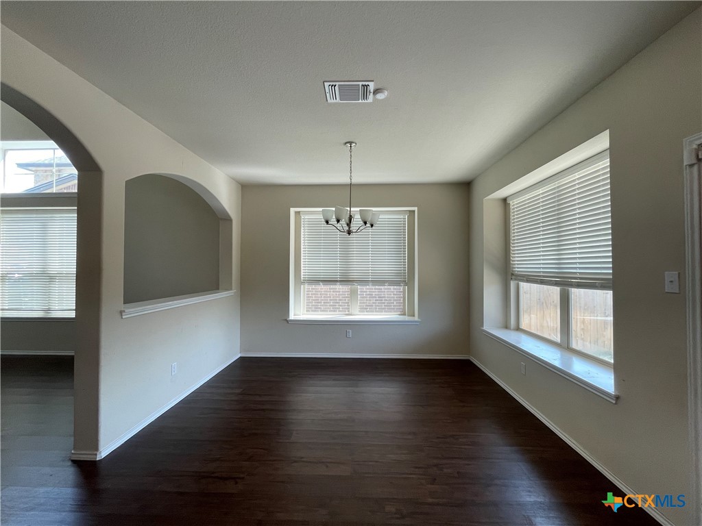 6416 Treiber Drive Temple, TX 76502 - Photo 7 of 19 a view of an empty room with wooden floor and a window